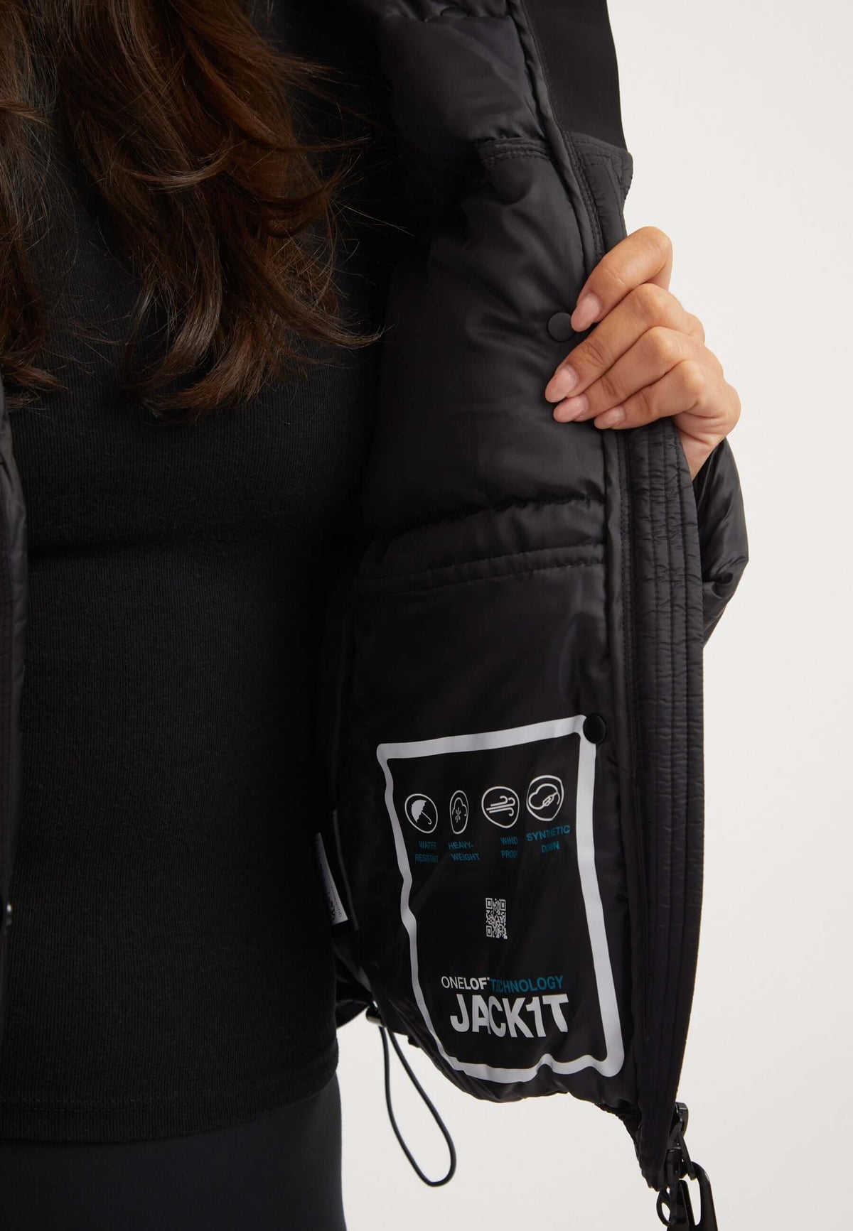 Close-up of the Cloud Boss Jacket Black interior, showcasing care instructions for the womens black puffer jacket.