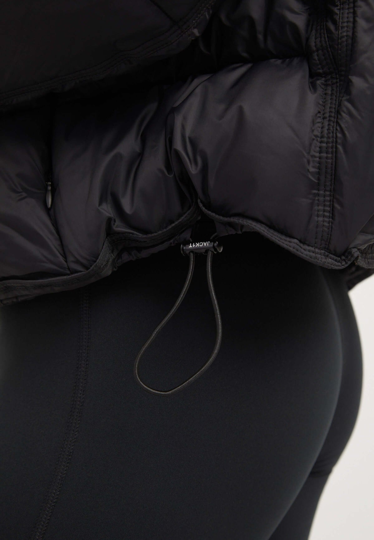 Close-up of the Cloud Boss Jacket Black showcasing the oversized drop shoulder and adjustable hem for a stylish fit. womens black puffer jacket.