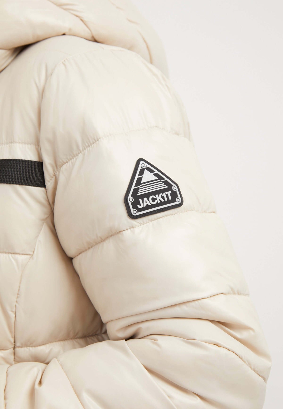 R3D Slick Racer Jacket Stone close-up view featuring reflective badge, sleek design, and puffer texture, womens racer puffer.