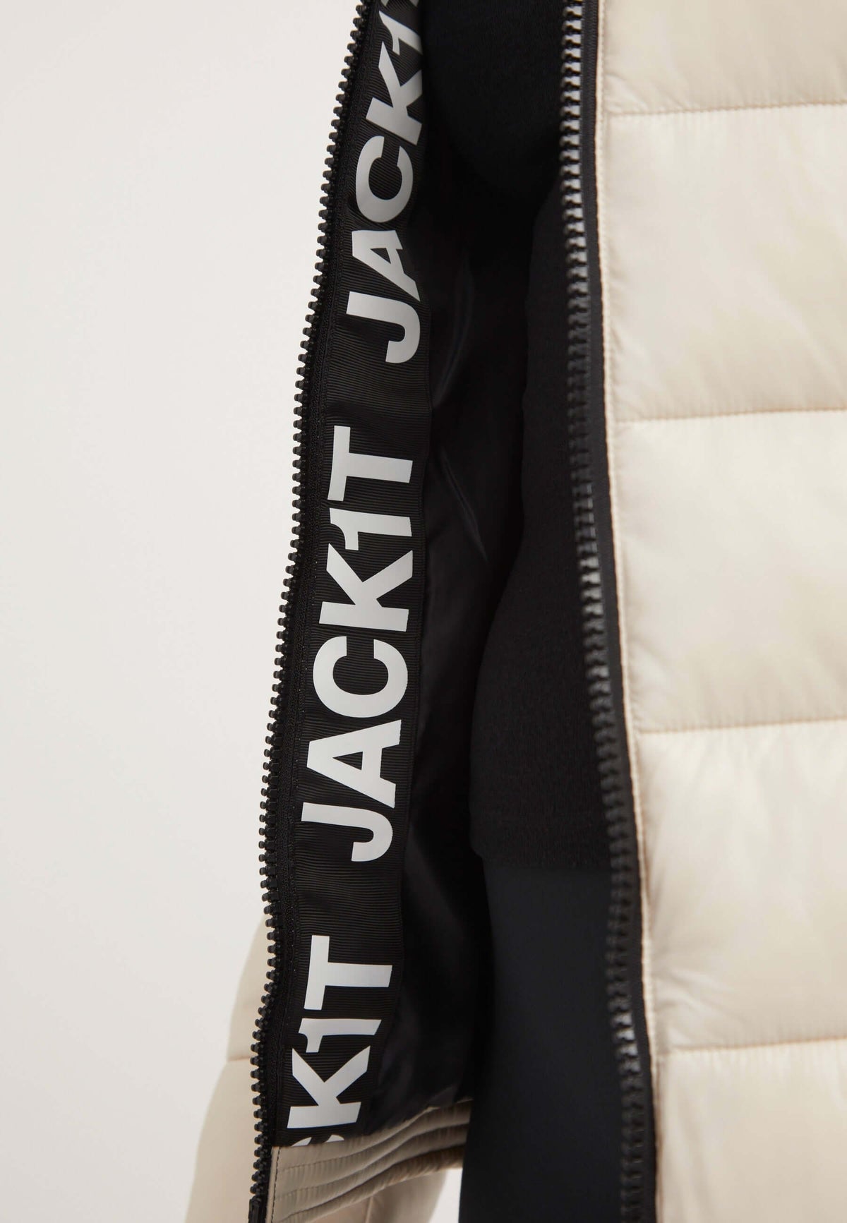 Interior view of the R3D Slick Racer Jacket showing branding, emphasizing womens racer puffer features and stylish design.