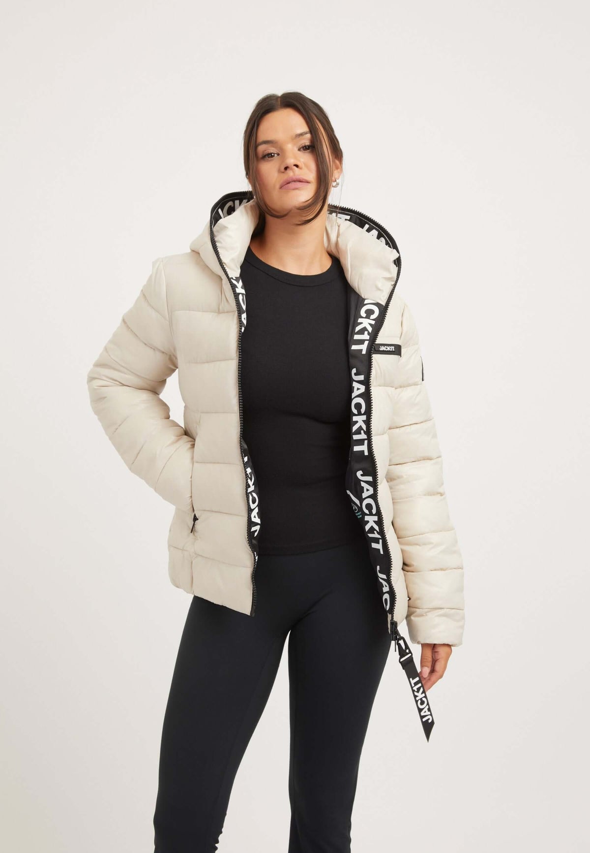 Wearing R3D Slick Racer Jacket Stone, a womens racer puffer with a tapered fit and premium insulation.