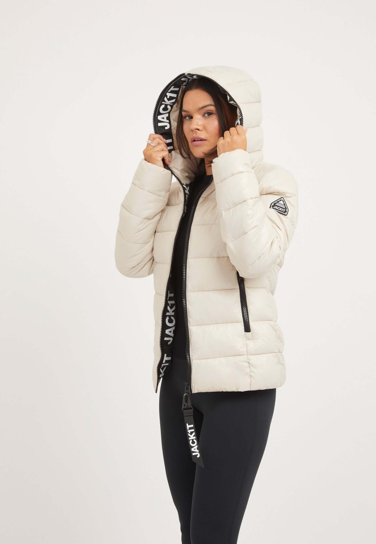 Model wearing R3D Slick Racer Jacket Stone, a womens racer puffer with elastic cuffs and two-way zips.