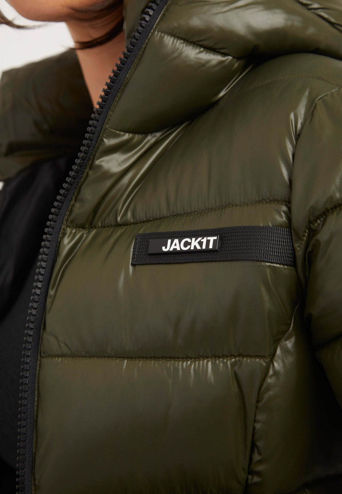 Close-up of R3D Slick Racer Jacket Olive with reflective badge, showcasing premium synthetic insulation and fitted puffer jacket style.