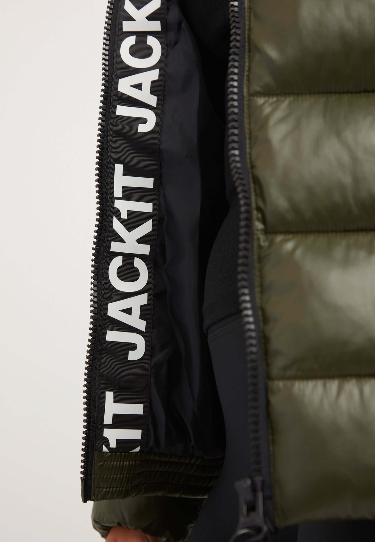 Detail of R3D Slick Racer Jacket Olive featuring fitted puffer jacket design with bold branding and zip closure.