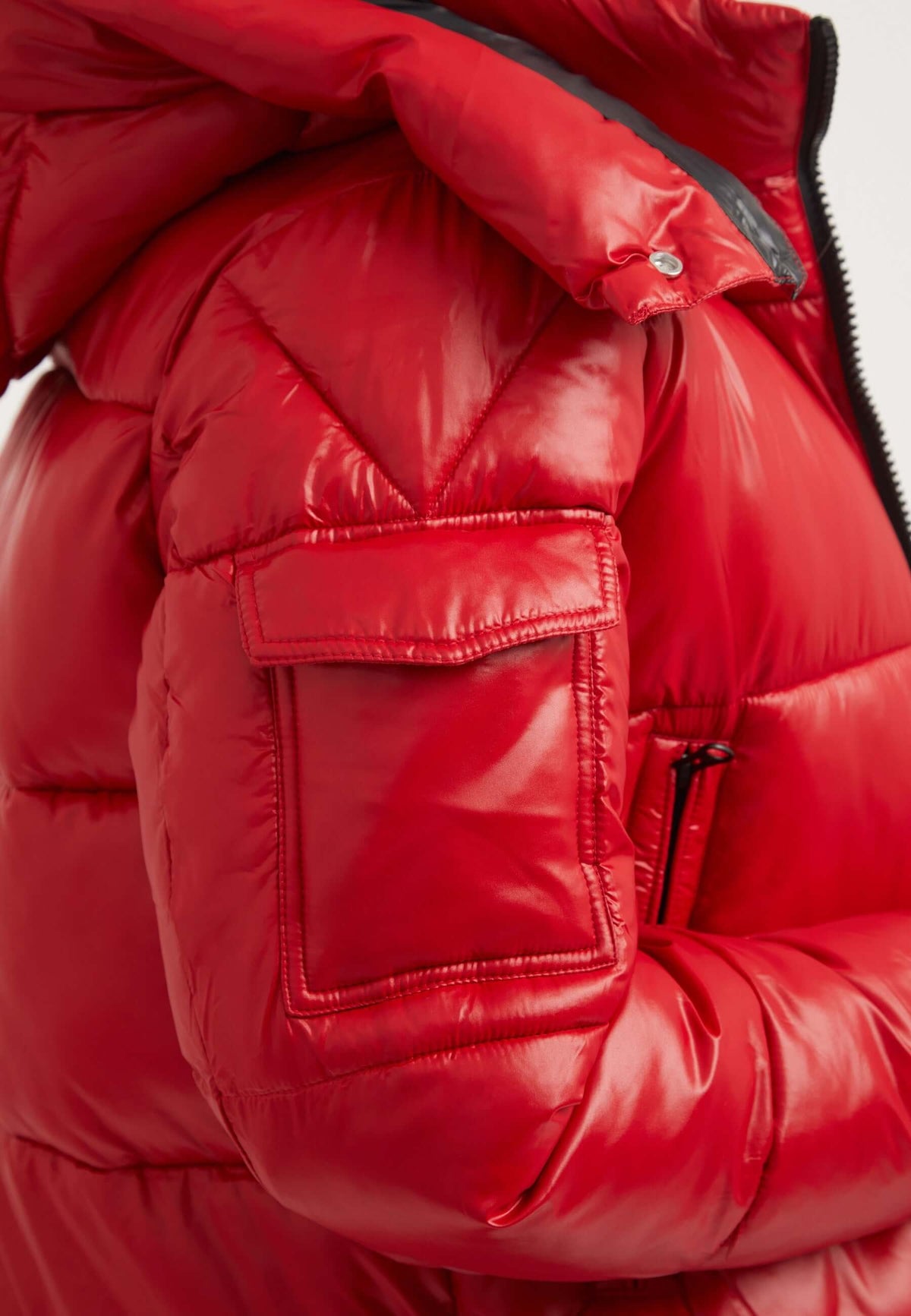 Close-up of EZ Racer Slick Hood Jacket in cherry red, showcasing puffer design and pocket details. Perfect red puffer jacket.