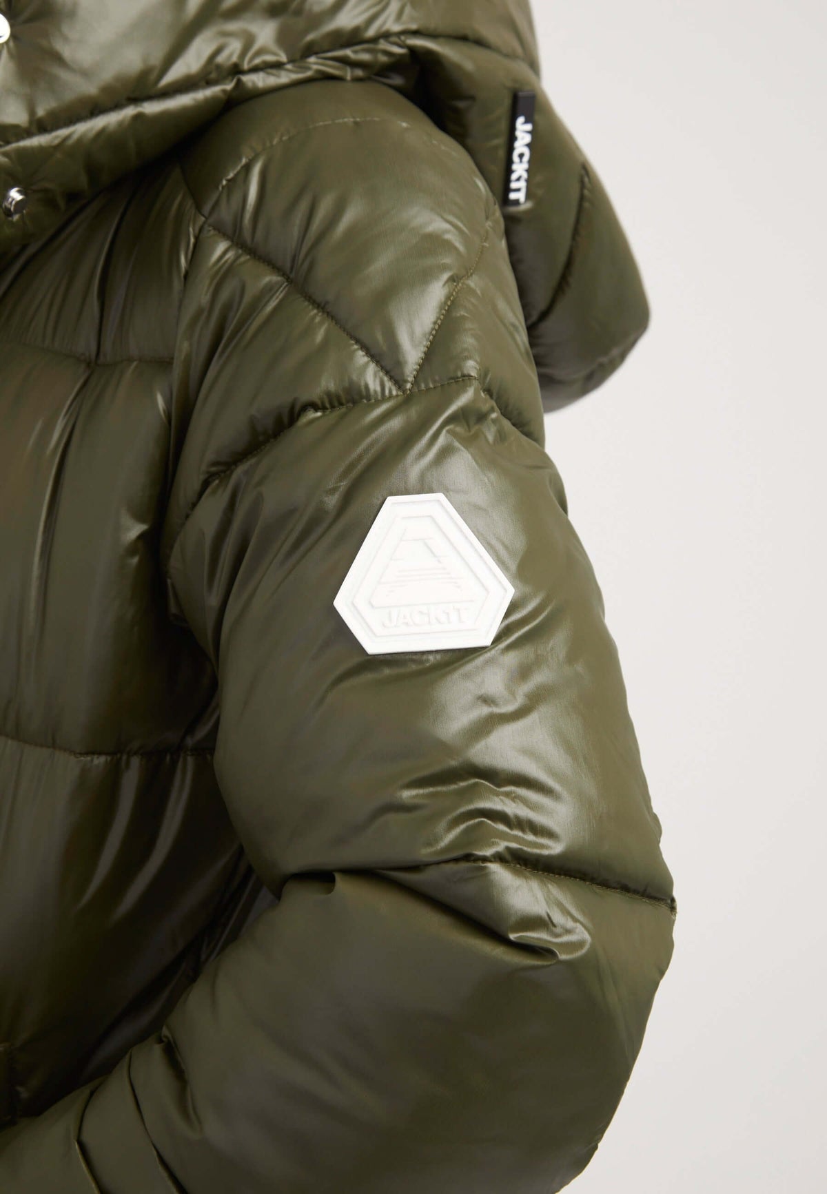 Close-up of olive EZ Slick Ultra Long Coat showing arm with logo, highlighting features of the extra long puffer coat.
