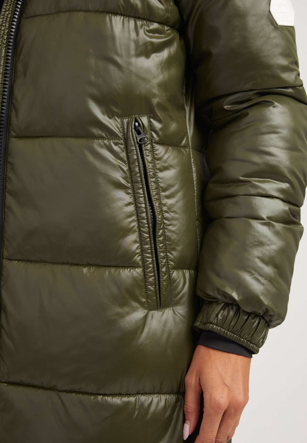 Close-up of EZ Slick Ultra Long Coat in Olive, featuring pocket detail, showcasing the extra long puffer coat design.