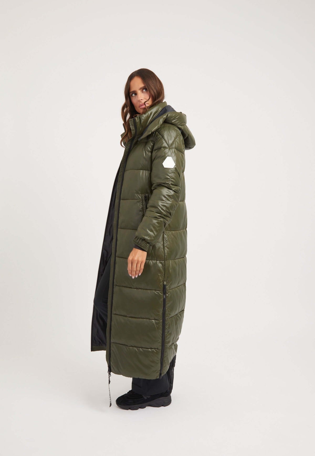 Model wearing EZ Slick Ultra Long Coat Olive, showcasing the extra long puffer coat with a removable hood.