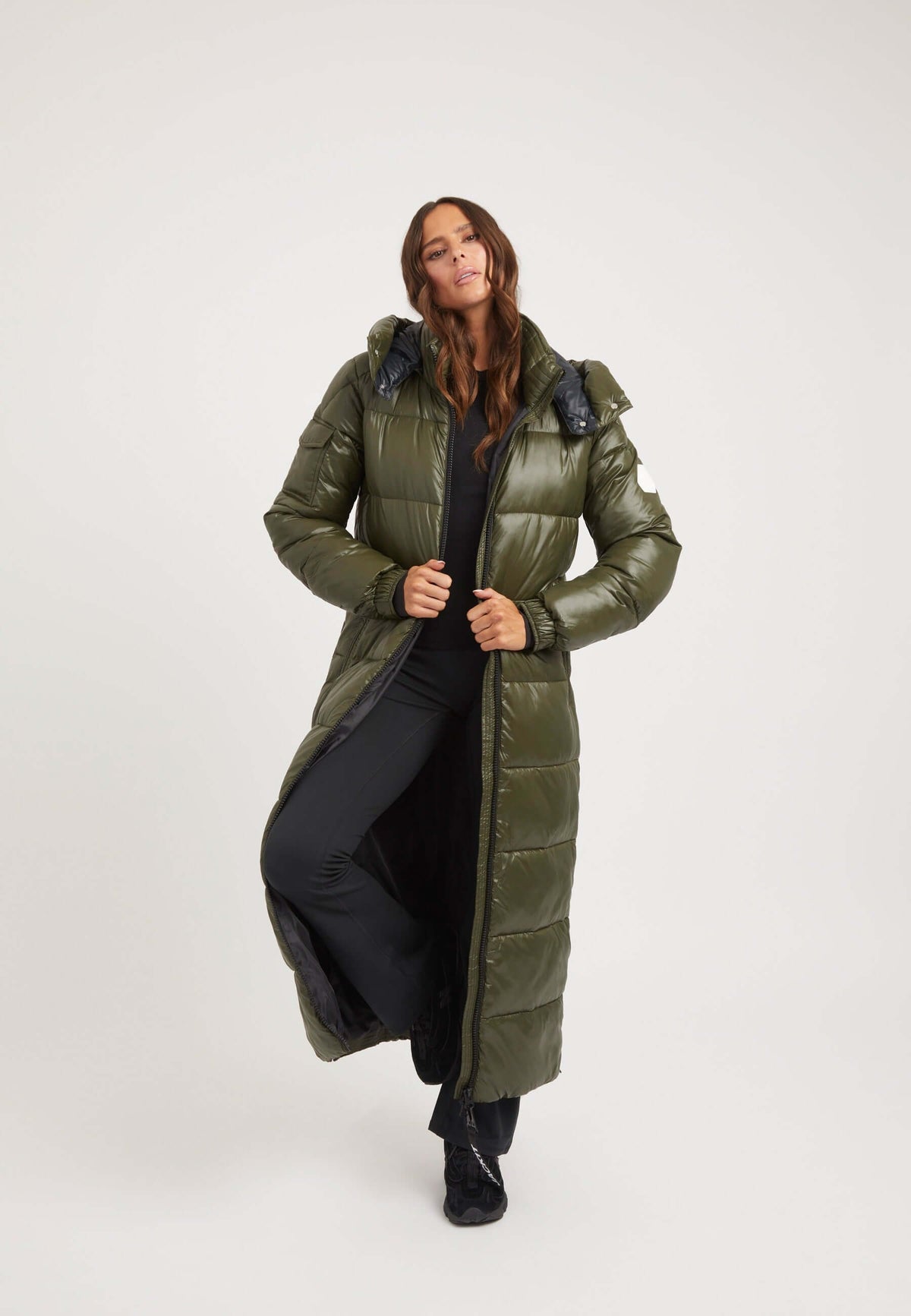 Model wearing an EZ Slick Ultra Long Coat Olive, showcasing extra long puffer coat design with premium insulation and hood.