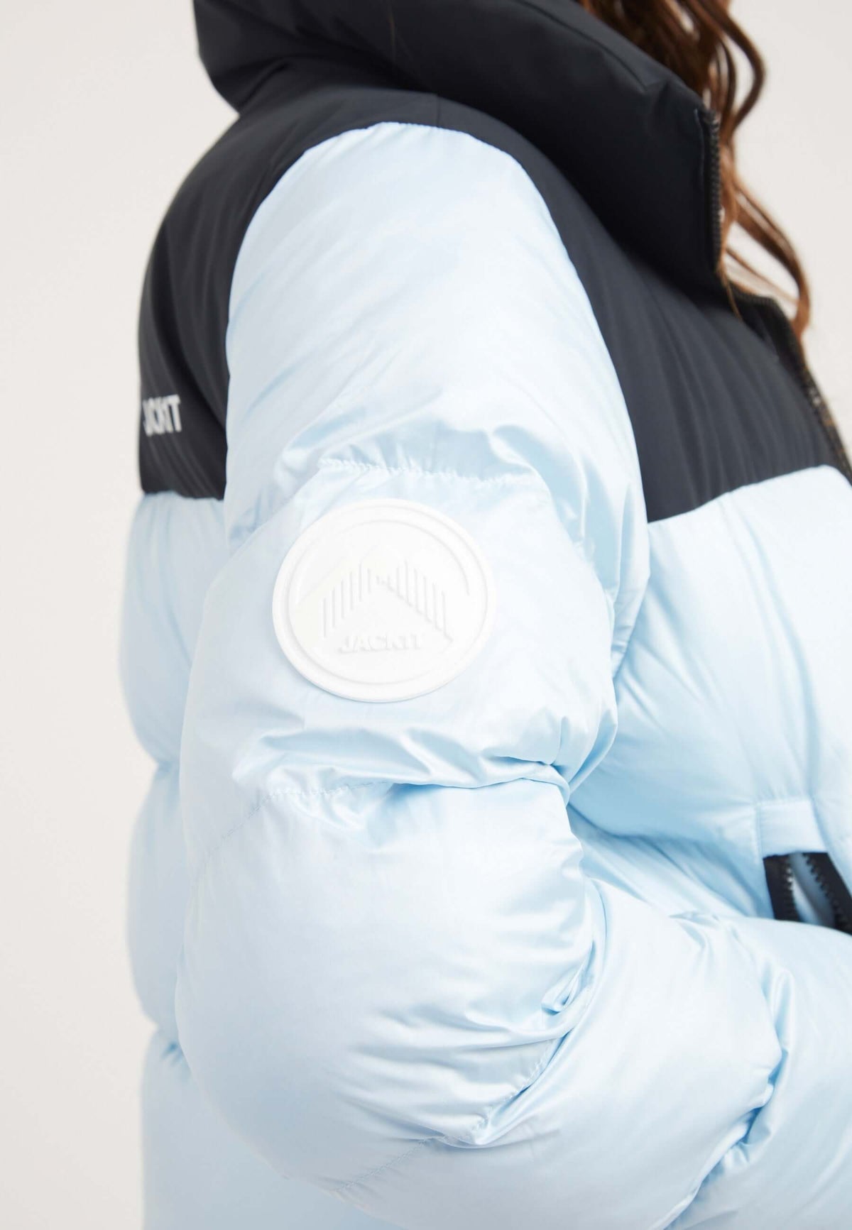 Funnel neck jacket in powder blue and black with premium insulation and contrasting color panels.