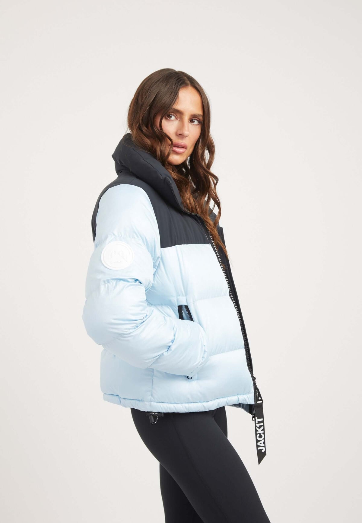 Powder blue and black funnel neck jacket with tapered racer fit and contrasting color panels.