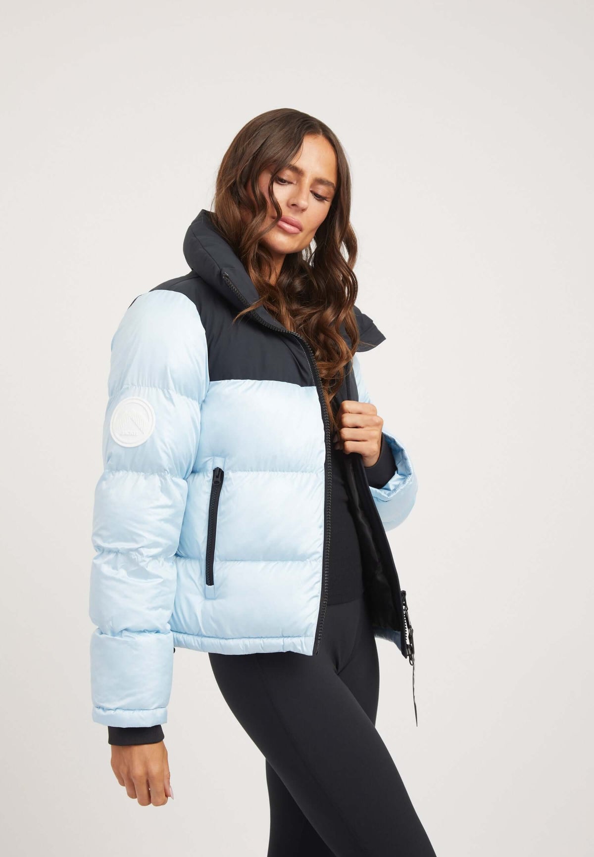 Model wearing a Powder Blue Black Funnel neck jacket with tapered racer fit and contrasting color panels.