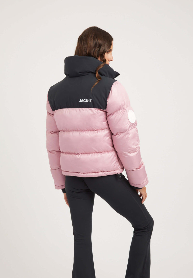 Woman wearing a Powder Pink and Black Funnel neck jacket with a tapered racer fit and contrasting color panels.