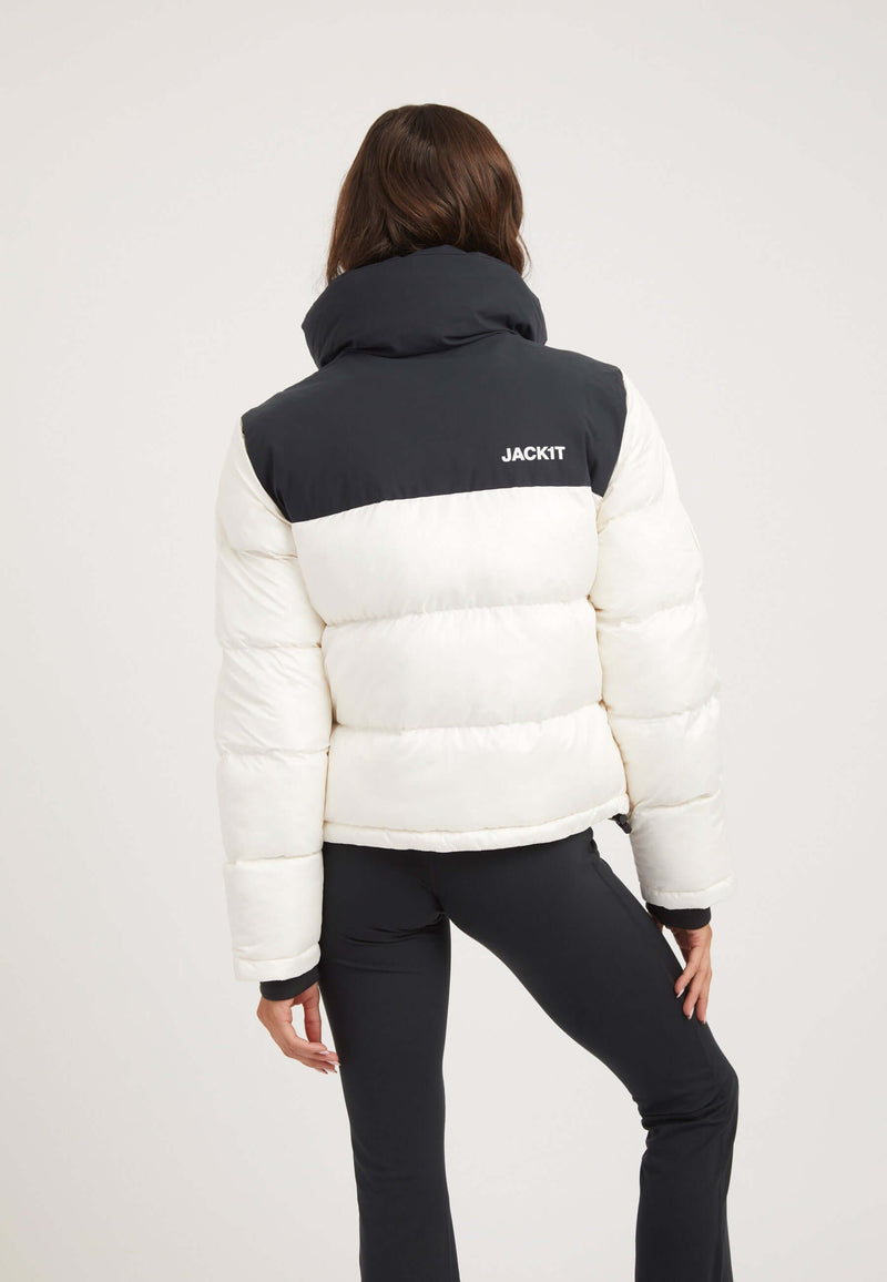 Model wearing the Diamond Funnel Jacket Snow Black, showcasing a funnel neck jacket with contrasting color panels.