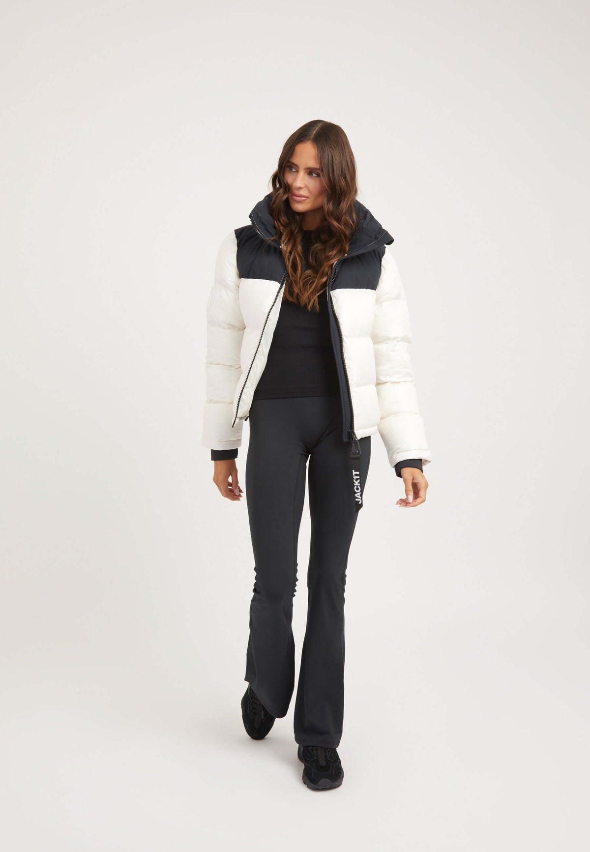 Model wearing a Diamond Funnel Jacket in Snow Black, featuring a funnel neck jacket design and sleek tapered fit.