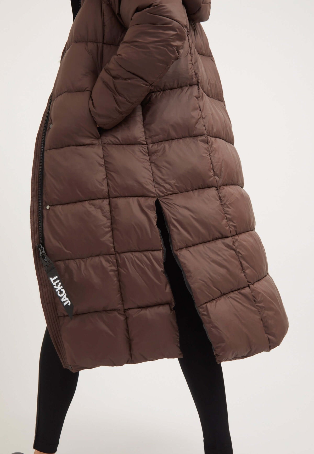 Womens long puffer coat in mid brown with side split opening and two way zips.