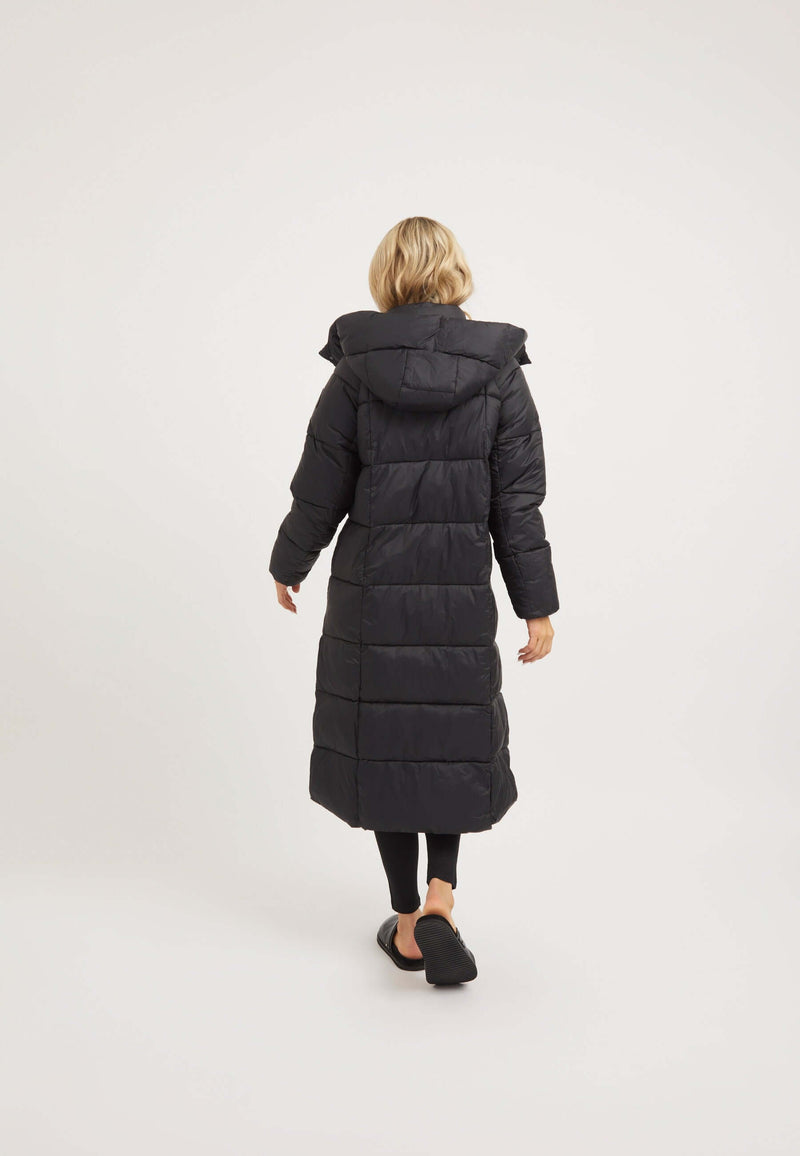 Back view of a woman wearing a Cloud Boss Coat Black, a womens long puffer coat, featuring a hood and full length design.
