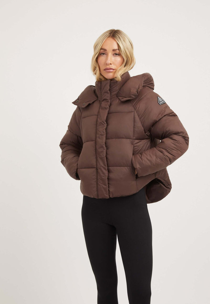 Short puffer jacket women in mid brown with adjustable hood and modern cropped cut.