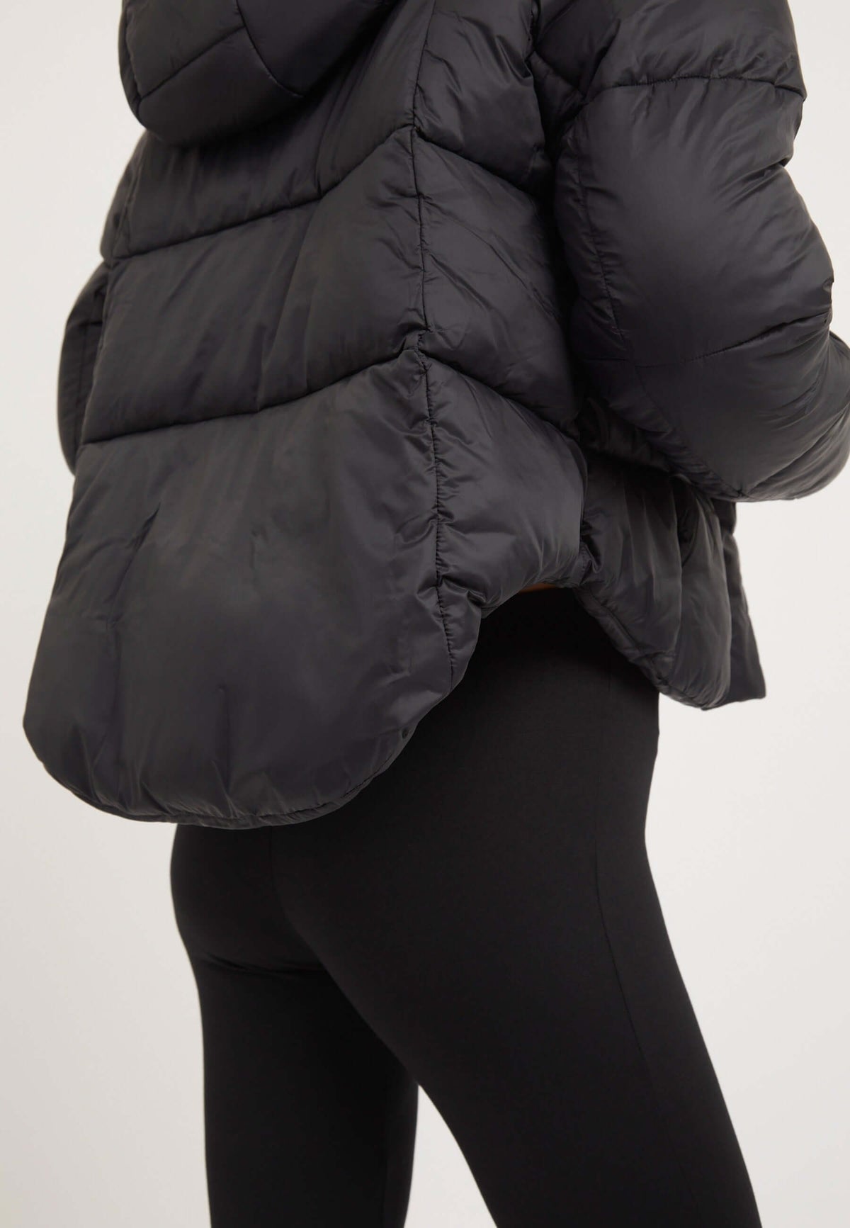 Womens short puffer jacket in black, featuring cropped cut and adjustable hood for modern silhouette and weather protection.