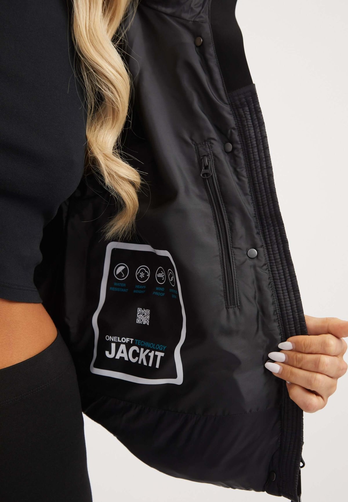Interior view of the Cloud Crop Jacket Black showing the ONELOFT™ insulation badge, highlighting features of the womens short puffer jacket.