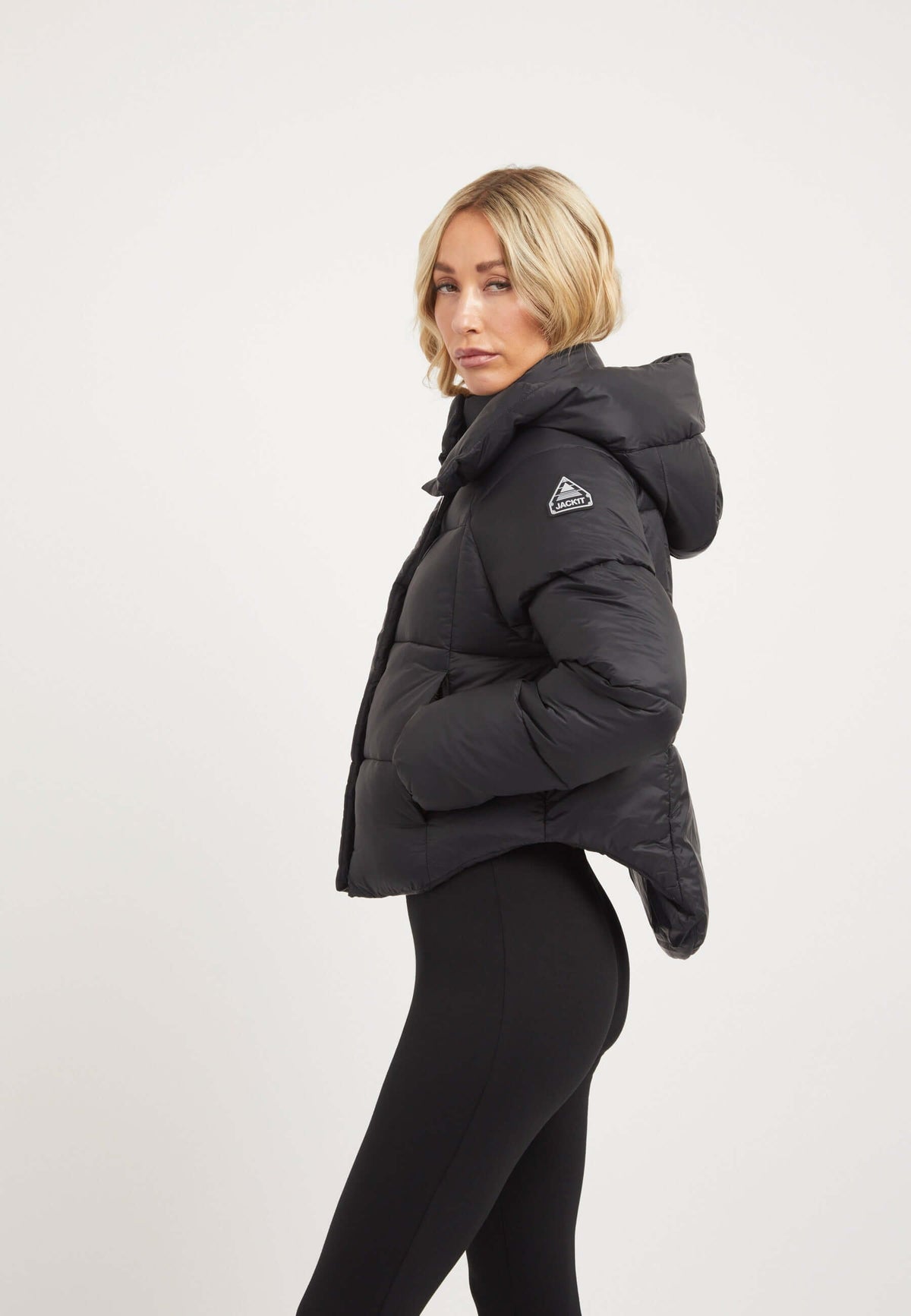 Womens short puffer jacket in black, featuring a cropped design and adjustable hood.
