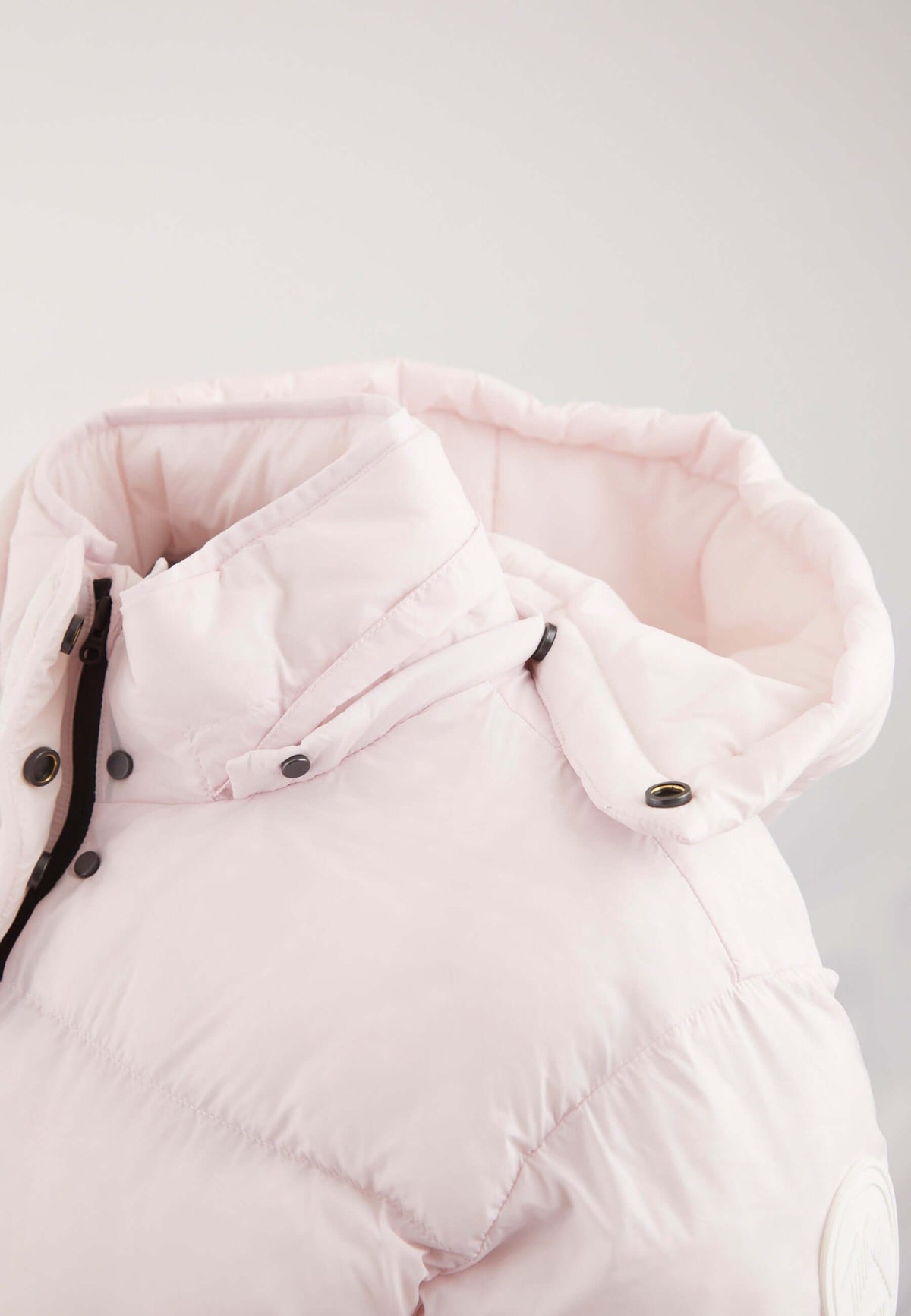 Short puffer jacket women in soft pink with adjustable hood and buttons for a stylish look.