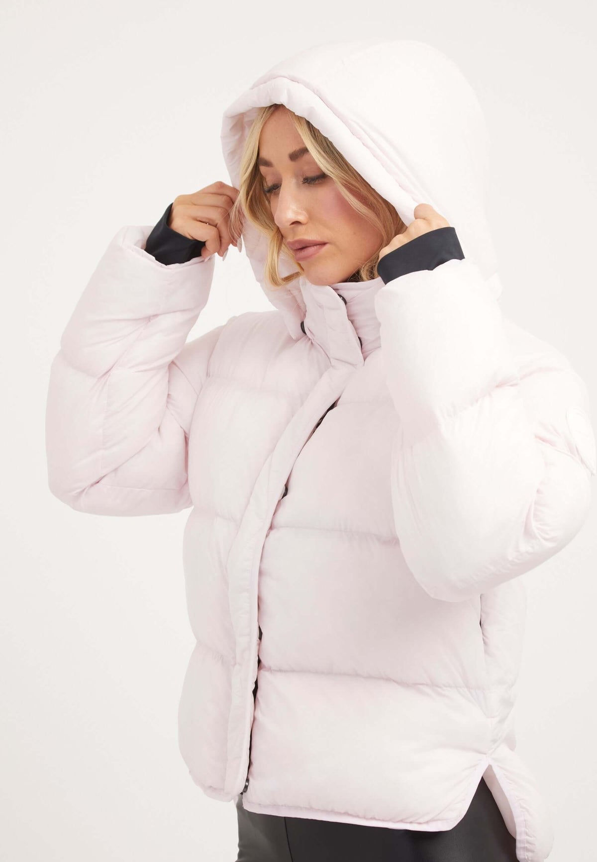 Short puffer jacket women in soft pink color featuring a hood and stylish cropped silhouette.