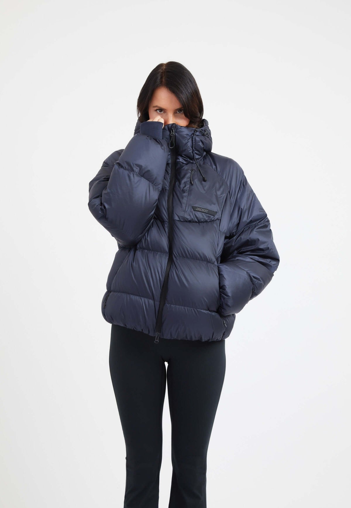 Model wearing an oversized puffer navy jacket, showcasing its cozy design and stylish fit.
