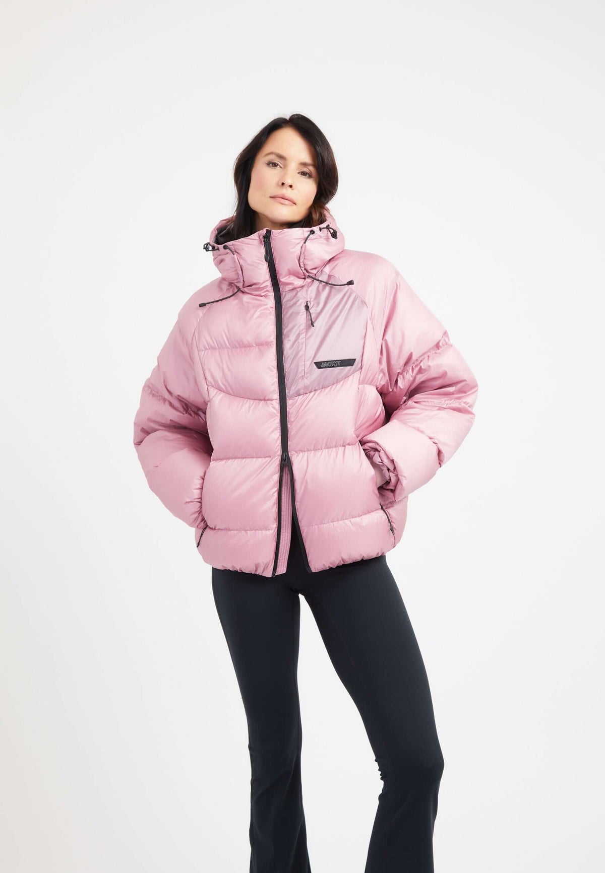 Model wearing an oversized puffer pink bubble jacket with adjustable hood and stylish design.