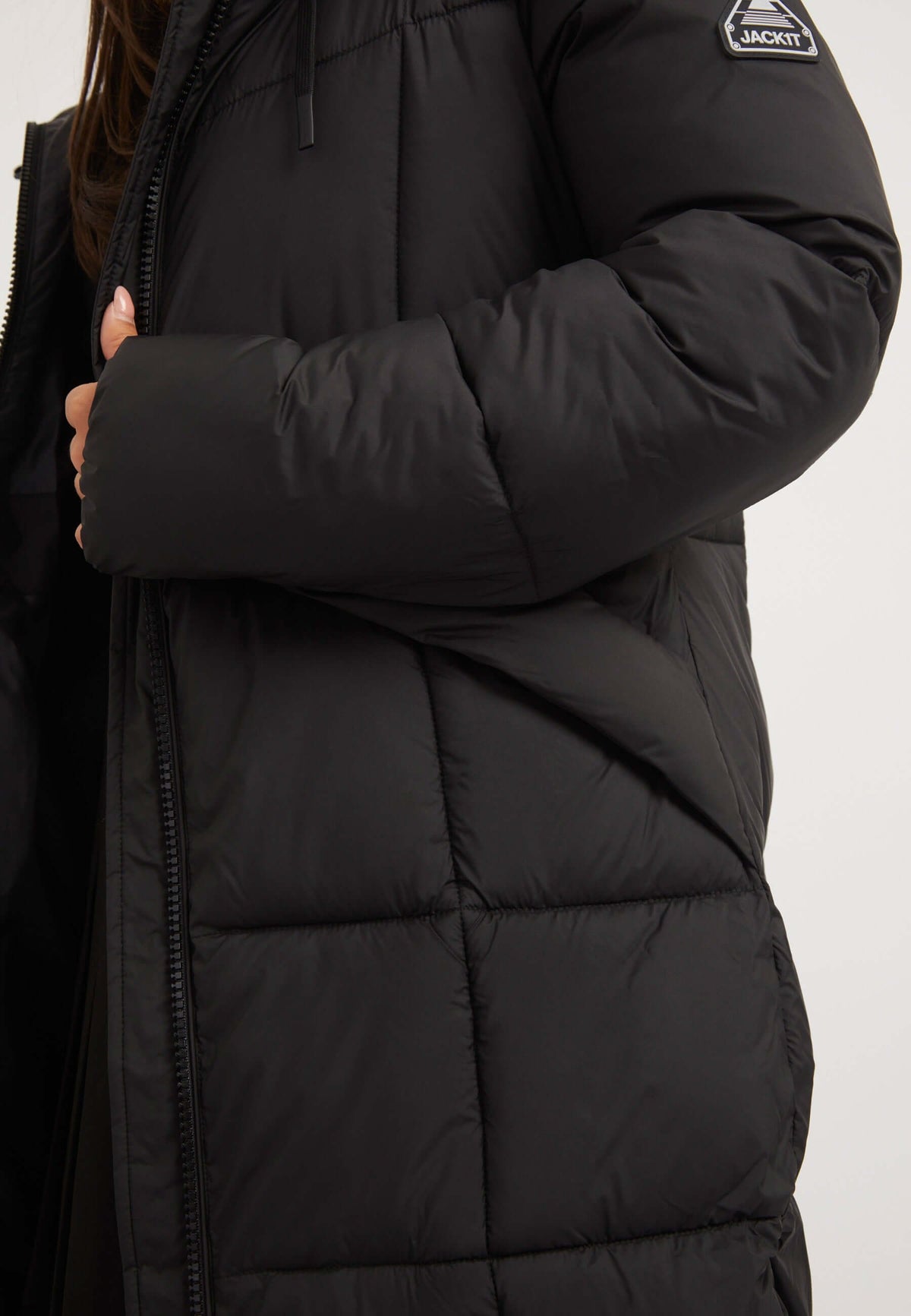Close-up of the Black Star extra long puffer coat showcasing its insulated fabric and stylish design.