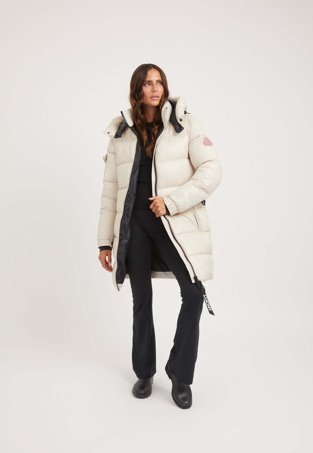 Model wearing EZ Belted Coat Stone, a stylish womens belted puffer coat with tapered fit and removable belt.