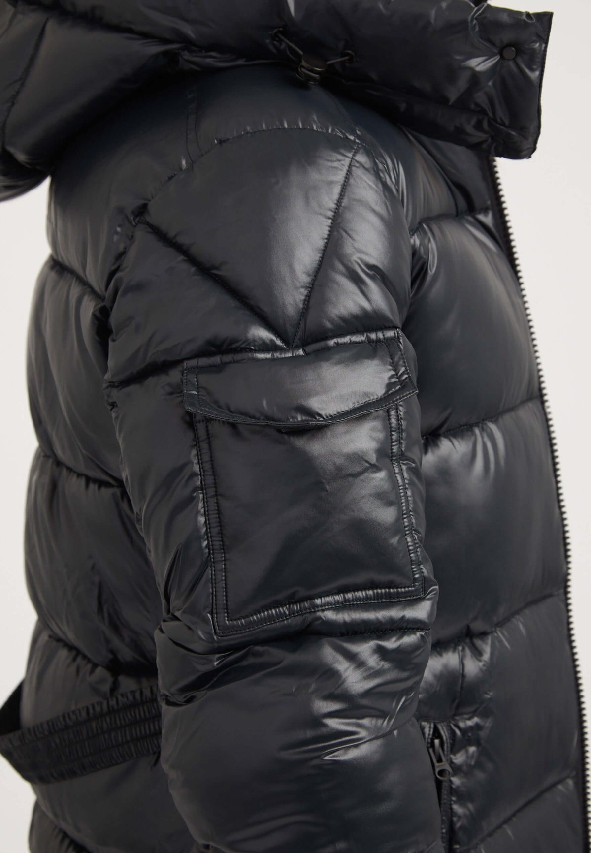 Close-up of womens belted coat black featuring shiny puffer texture and detachable hood.