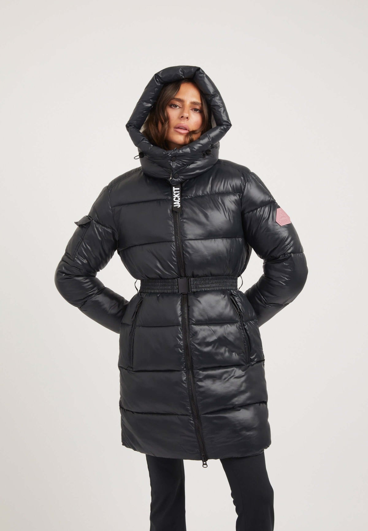 womens belted coat black worn by model with hood and belt, featuring premium insulation and a sleek design.