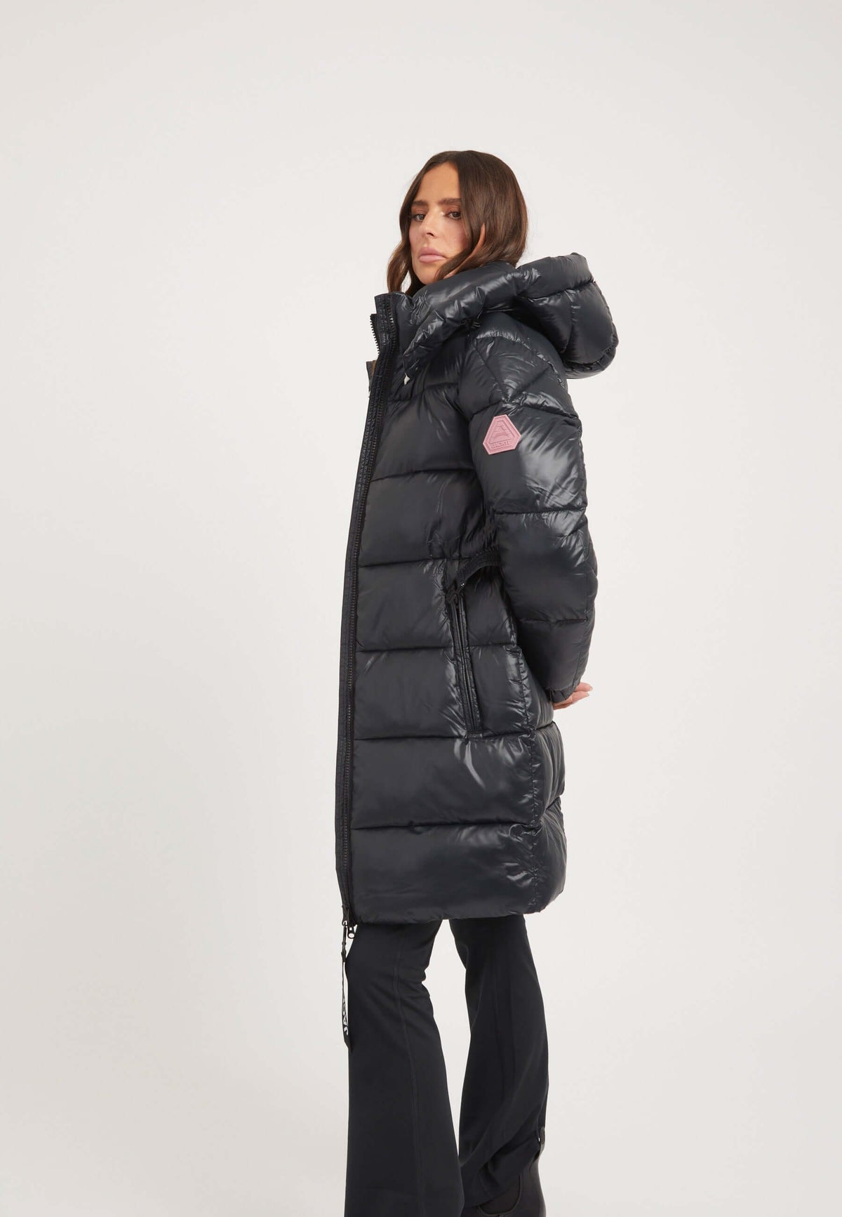Womens belted coat black shown from side with tapered above knee cut and grown-on hood