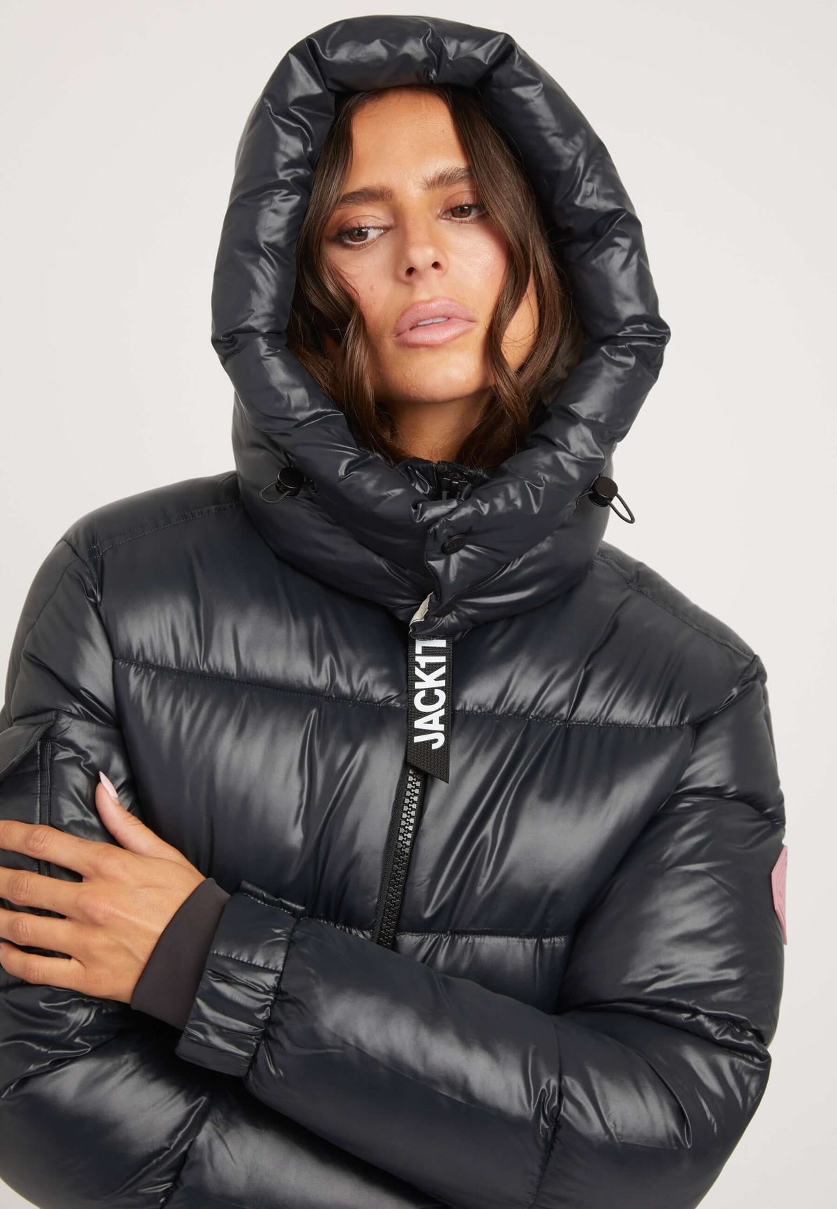 womens belted coat black worn by model with hood and shiny fabric, showcasing premium insulation and stylish design.