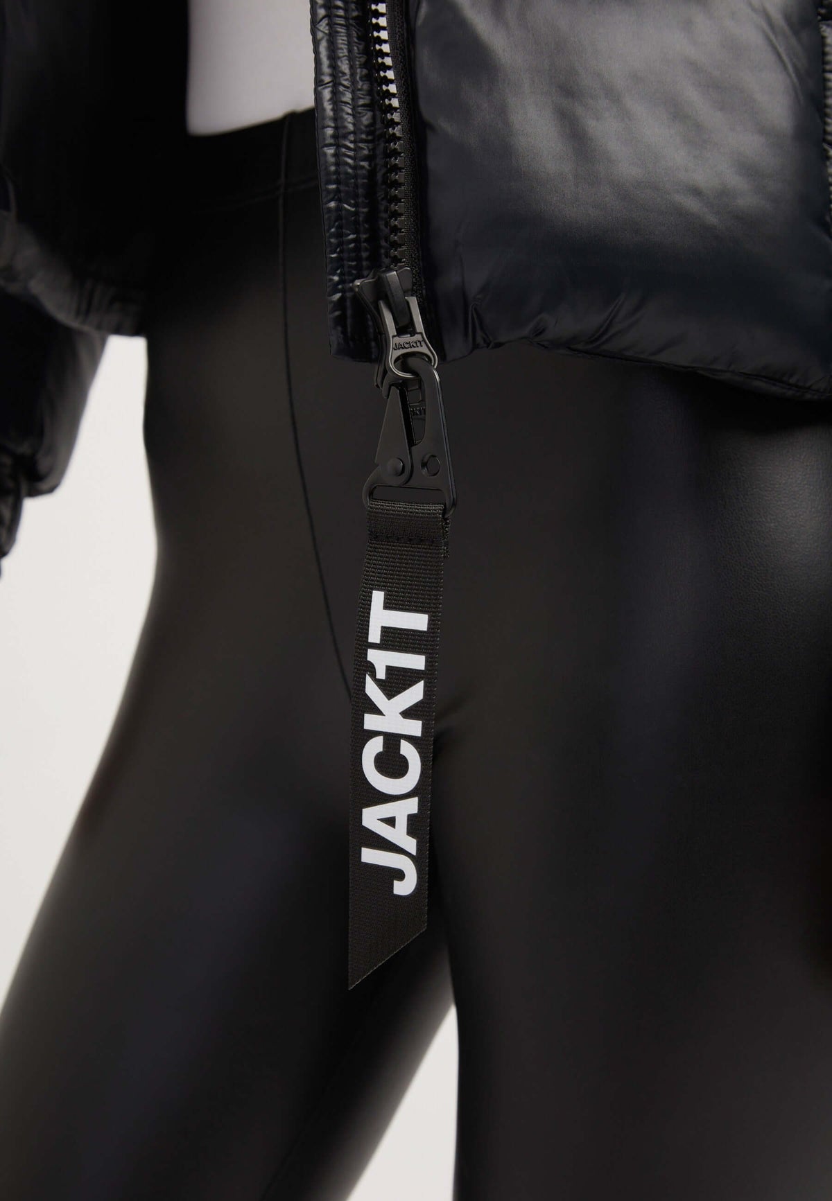 Close-up of EZ Box Crop Jacket Black with zipper pull detail, showcasing short puffer jacket women style.