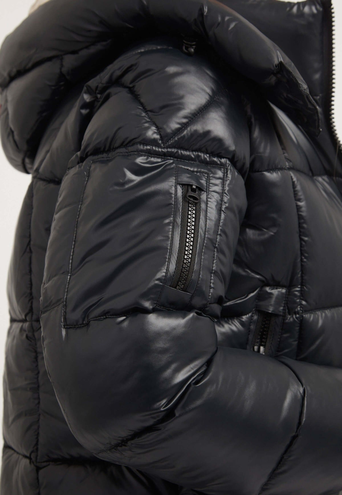 Side view of EZ Box Crop Jacket Black featuring premium synthetic insulation, grown-on hood, and zippers. Short puffer jacket women.