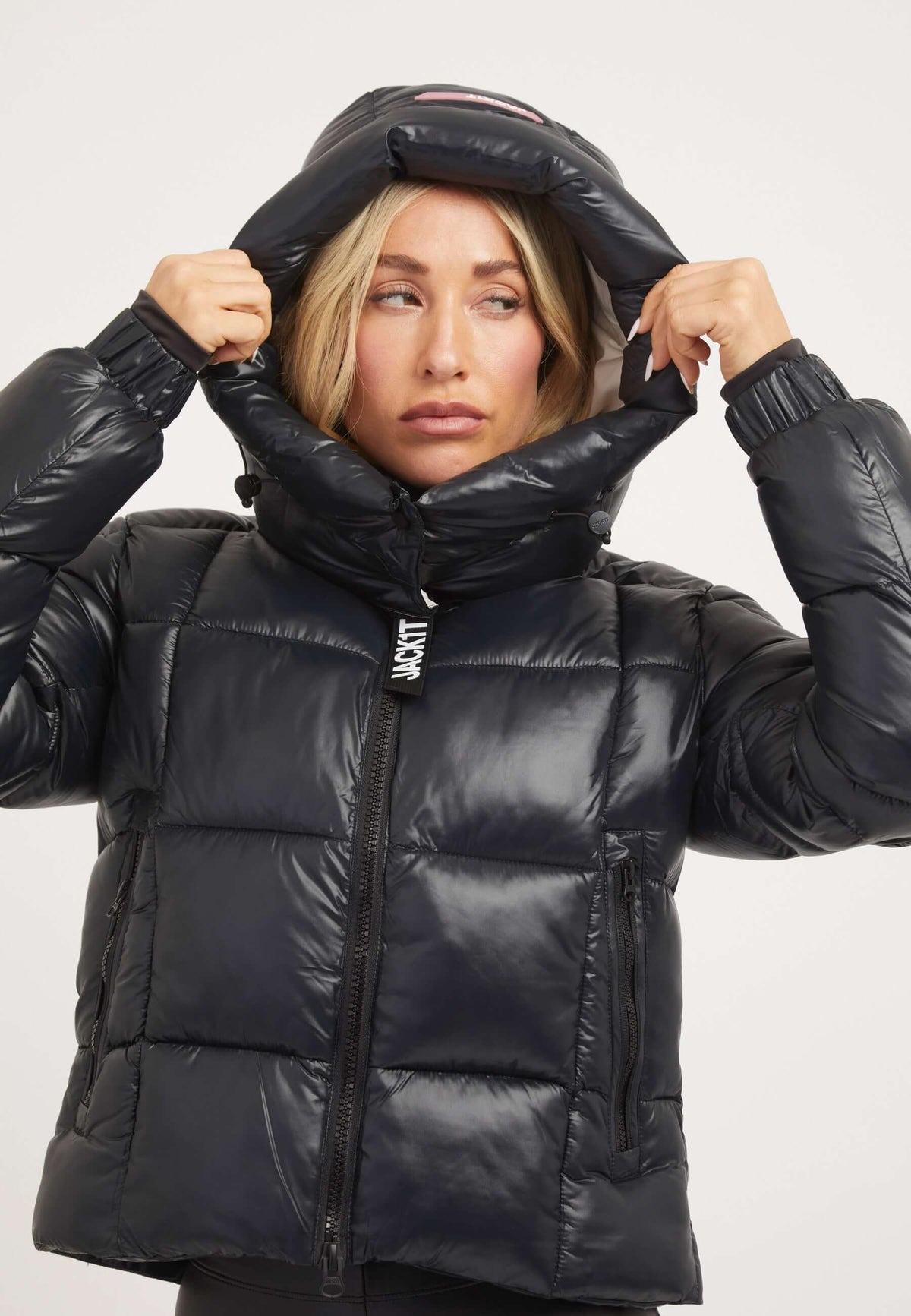 Model wearing EZ Box Crop Jacket Black, a short puffer jacket women with cropped fit and grown-on hood.