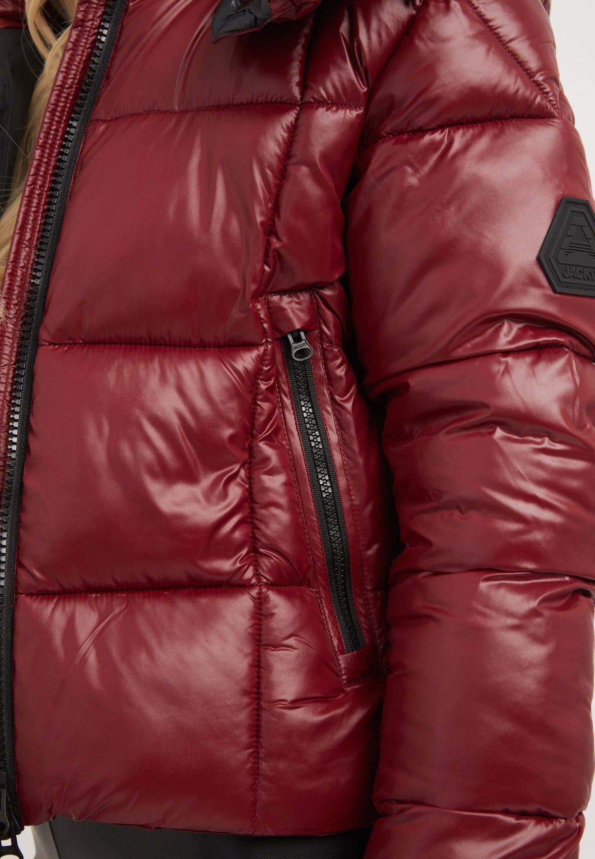 Dark cranberry short puffer jacket women with zip pocket and shiny finish, perfect for stylish winter wear.