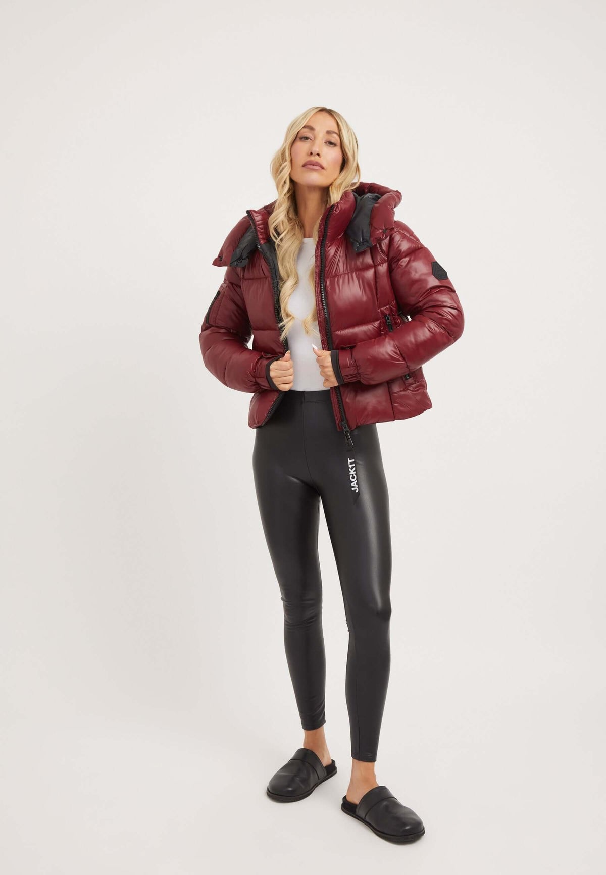 Model wearing EZ Box Crop Jacket Dark Cranberry, a chic short puffer jacket women, paired with sleek leggings.