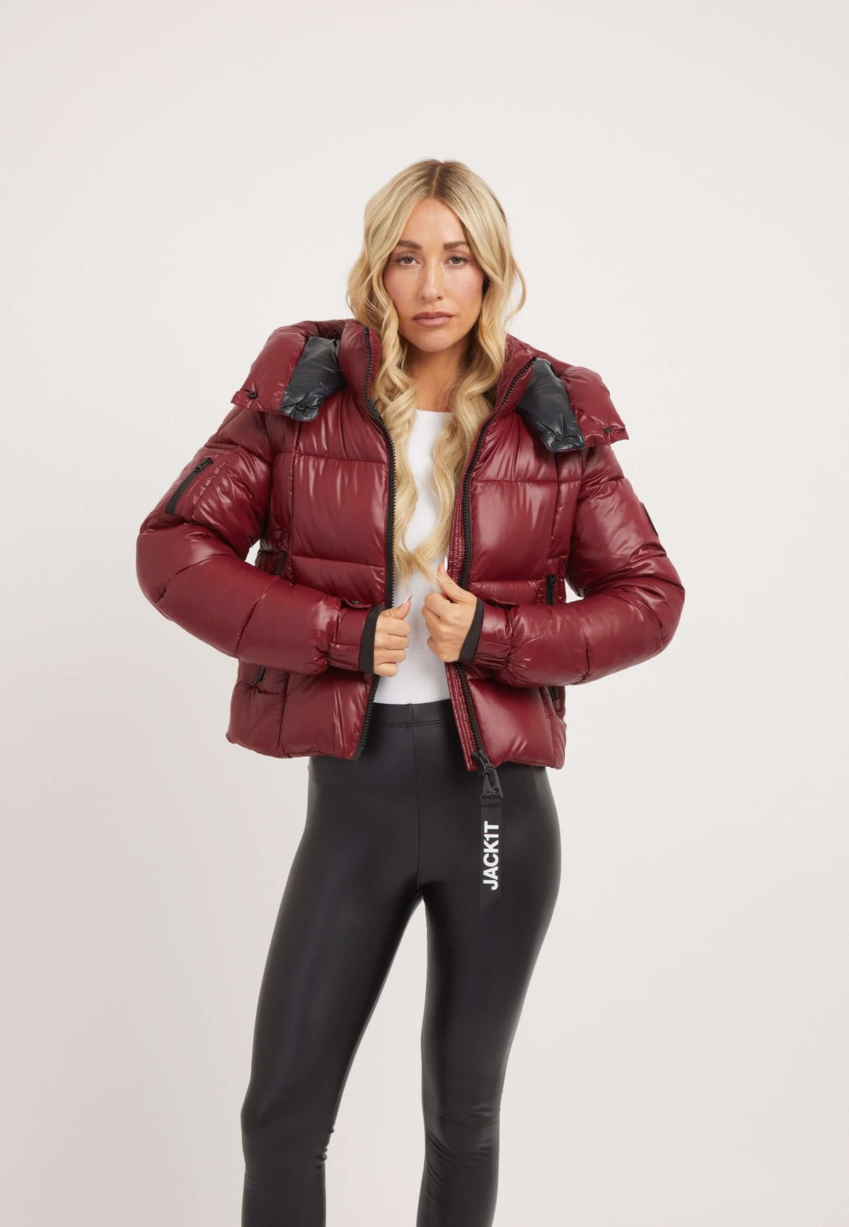 Model wearing EZ Box Crop Jacket in dark cranberry, showcasing a stylish short puffer jacket women design.