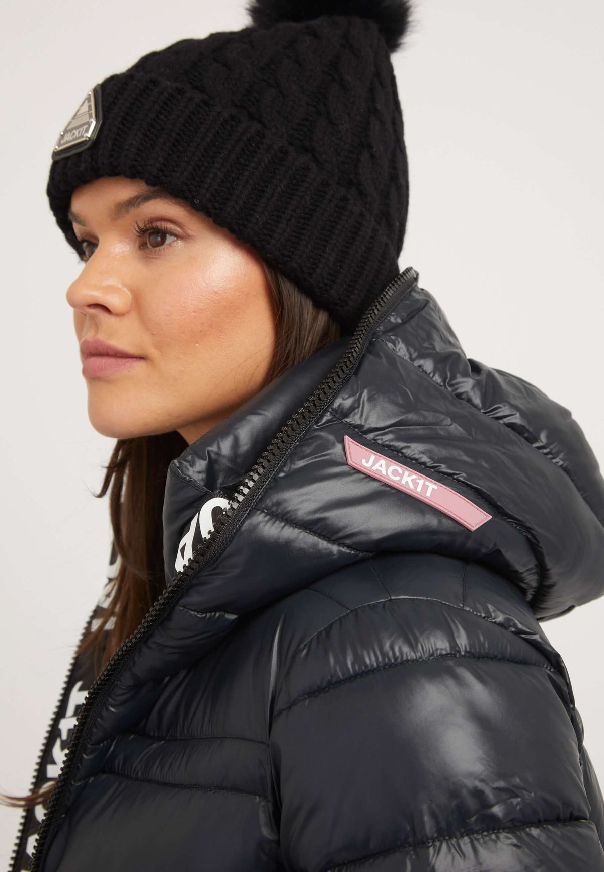 Model wearing the R4D Extra Long Puffer Coat in black with hood and beanie, showcasing premium insulation and stylish design.
