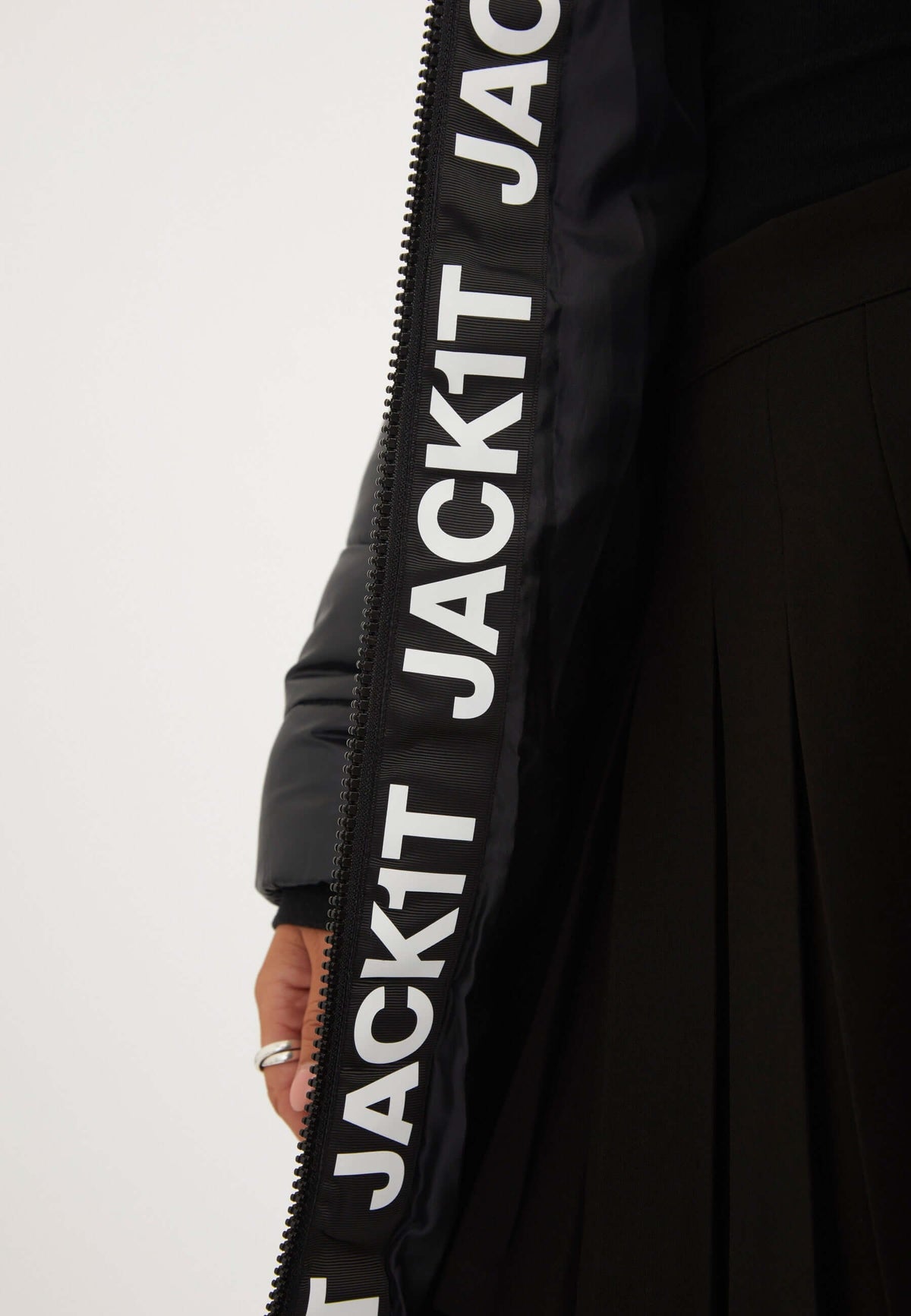 Black Extra Long Puffer Coat featuring logos along the zipper, showcasing premium waterproof material and stylish design.