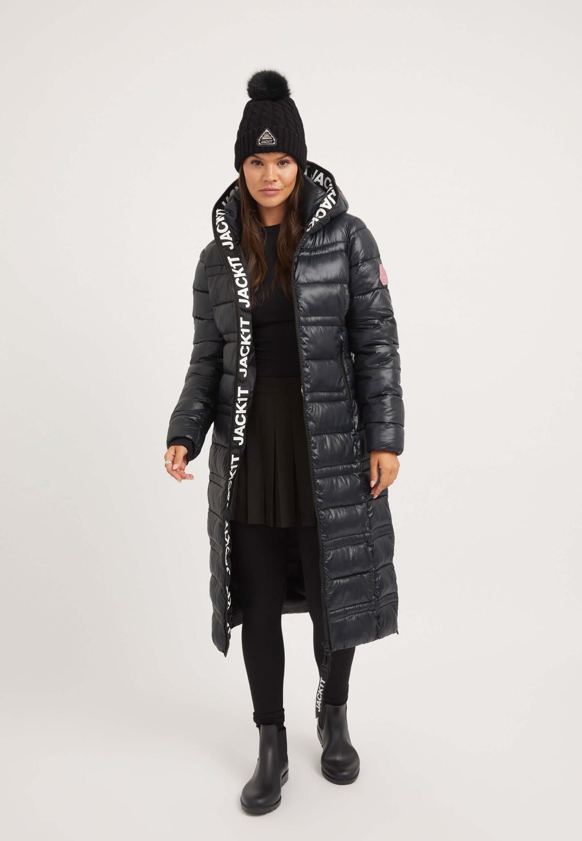 Model wearing R4D Extra Long Straight Baffle Coat Black with a black hat and skirt, showcasing the Extra Long Puffer Coat style.