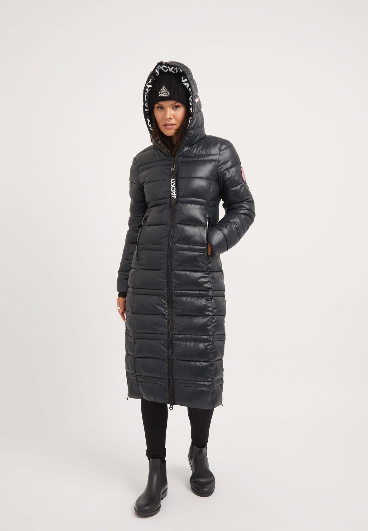 Model wearing R4D Extra Long Straight Baffle Coat Black, a stylish Extra Long Puffer Coat with hood and zips.