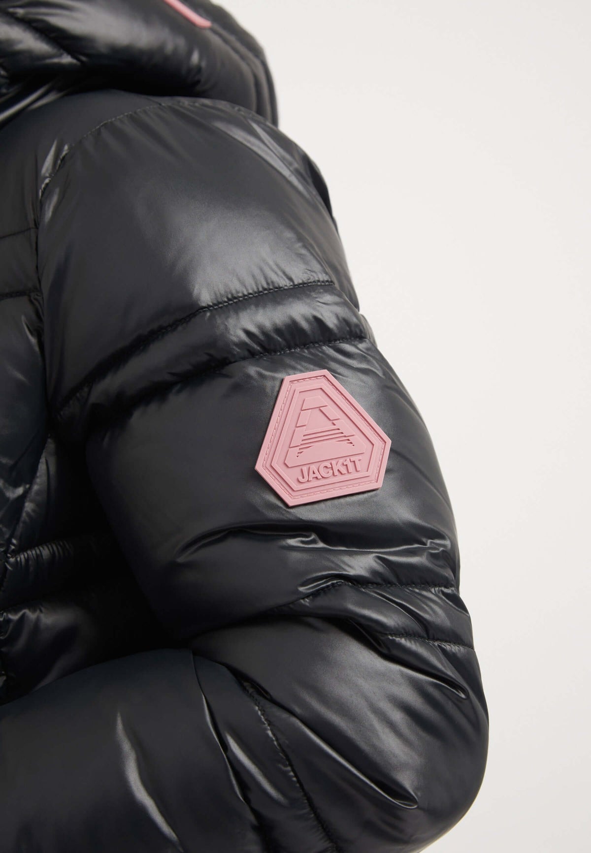 Close-up of R4D Tramline Racer Jacket Black showing the reflective badge on the sleeve. Perfect for ladies black puffer jacket.