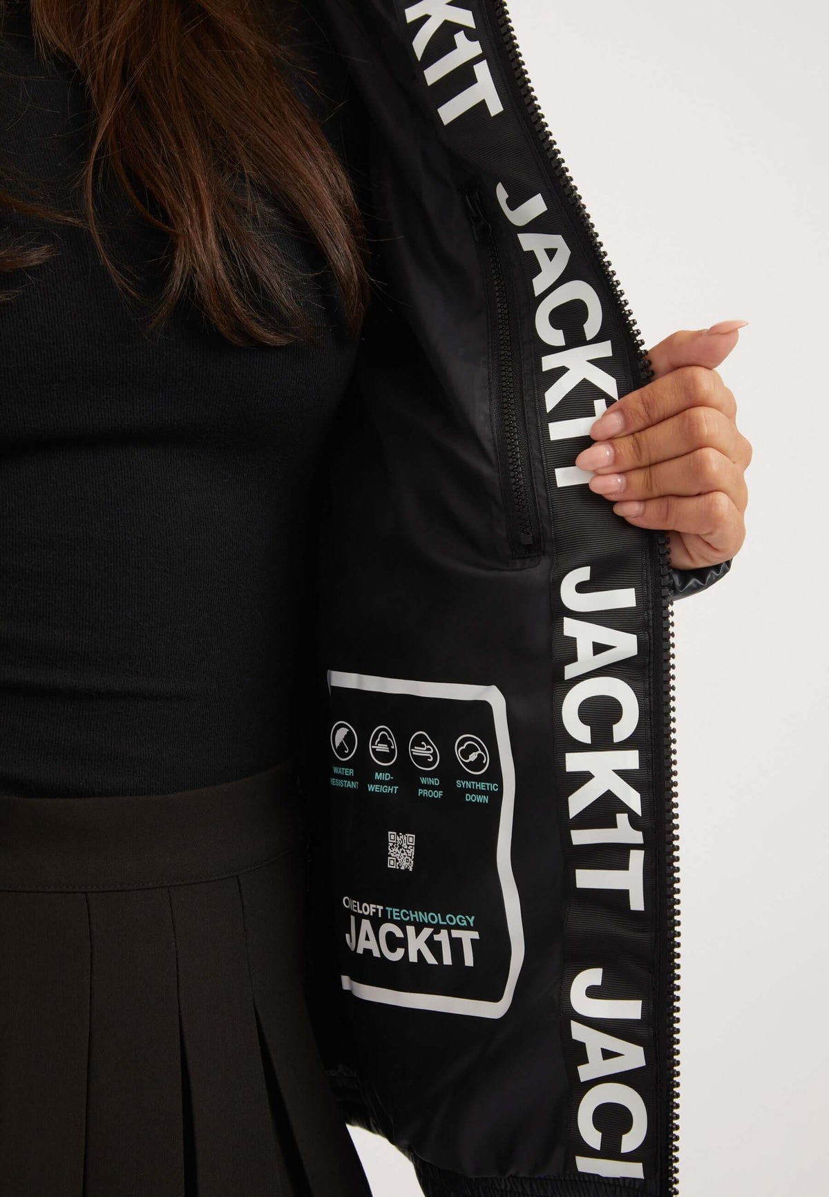 Inside view of ladies black puffer jacket showcasing JACK1T technology and washing instructions.