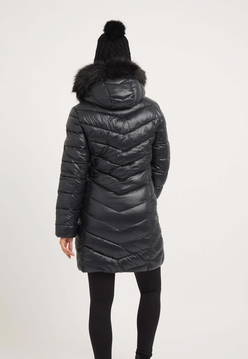 Back view of a black womens puffer coat with faux-fur trim hood, tapered design, and reflective badge.