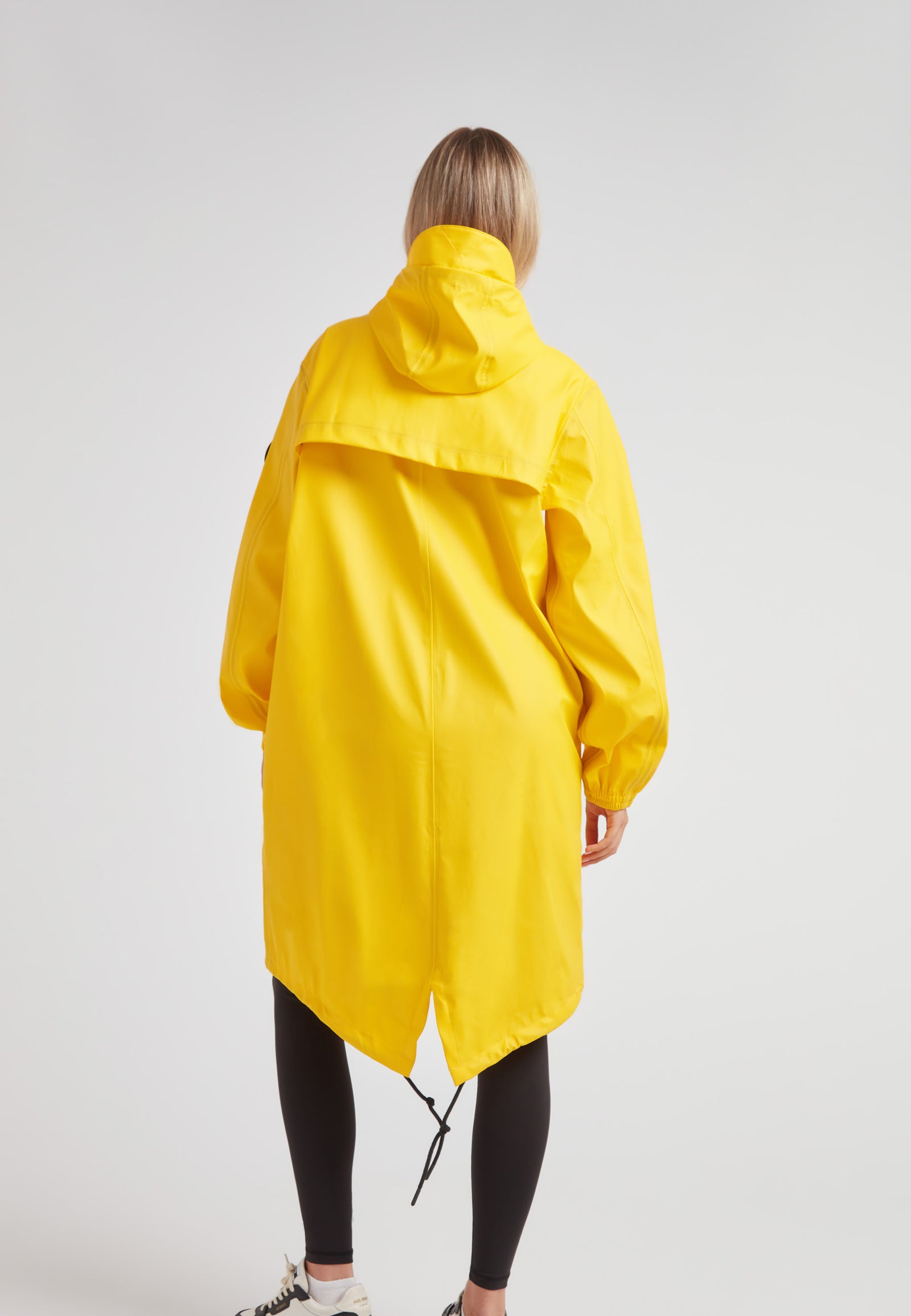 Yellow Elements longline raincoat showcased from the back, featuring a hood and lightweight design.
