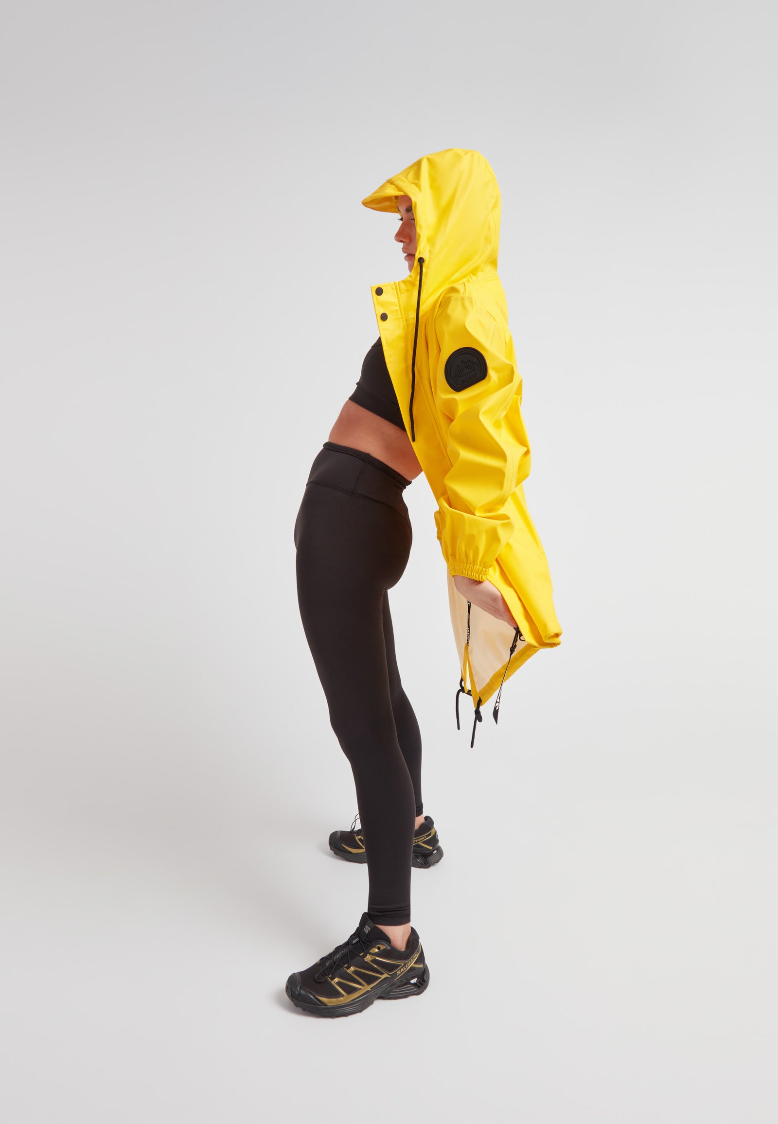 ELEMENTS Raincoat 2.0 Yellow worn by a model, showcasing its lightweight and stylish design.